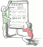 Two people writing ideas on a flipchart.